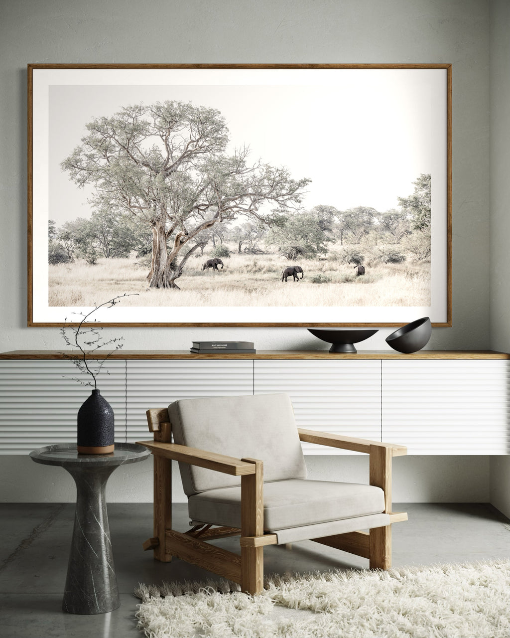 Modern interior featuring framed artwork print of elephants in a savanna landscape with a large tree from the wildlife collection by Francoise V Fine Art Gallery in Cape Town, South Africa
