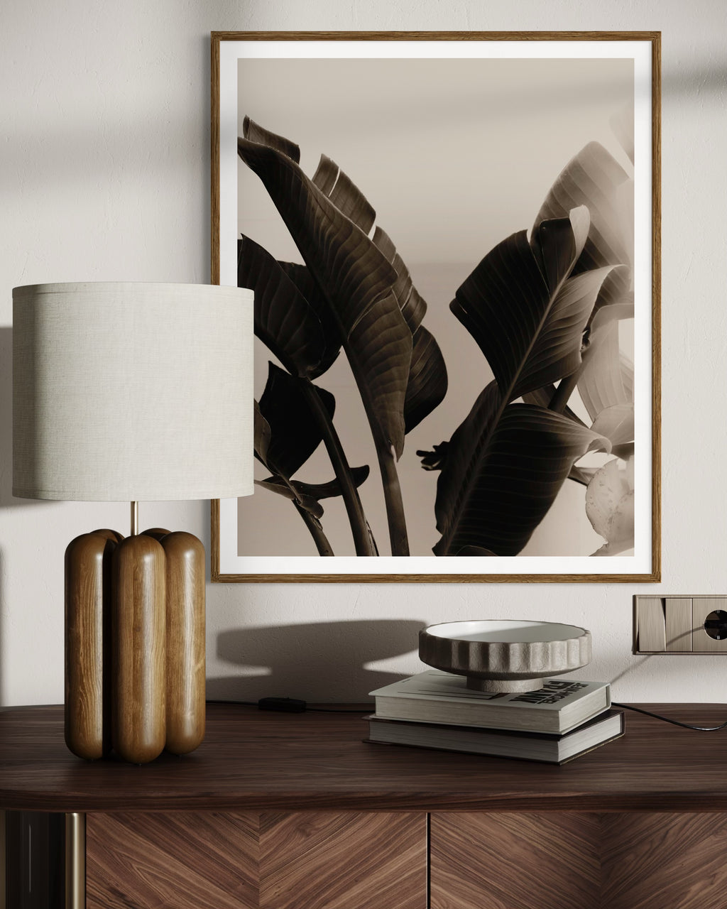 Earthy interior featuring a framed artwork of a close-up of tropical leaves with a blurred background by Francoise V Fine Art Gallery in Cape Town, South Africa.