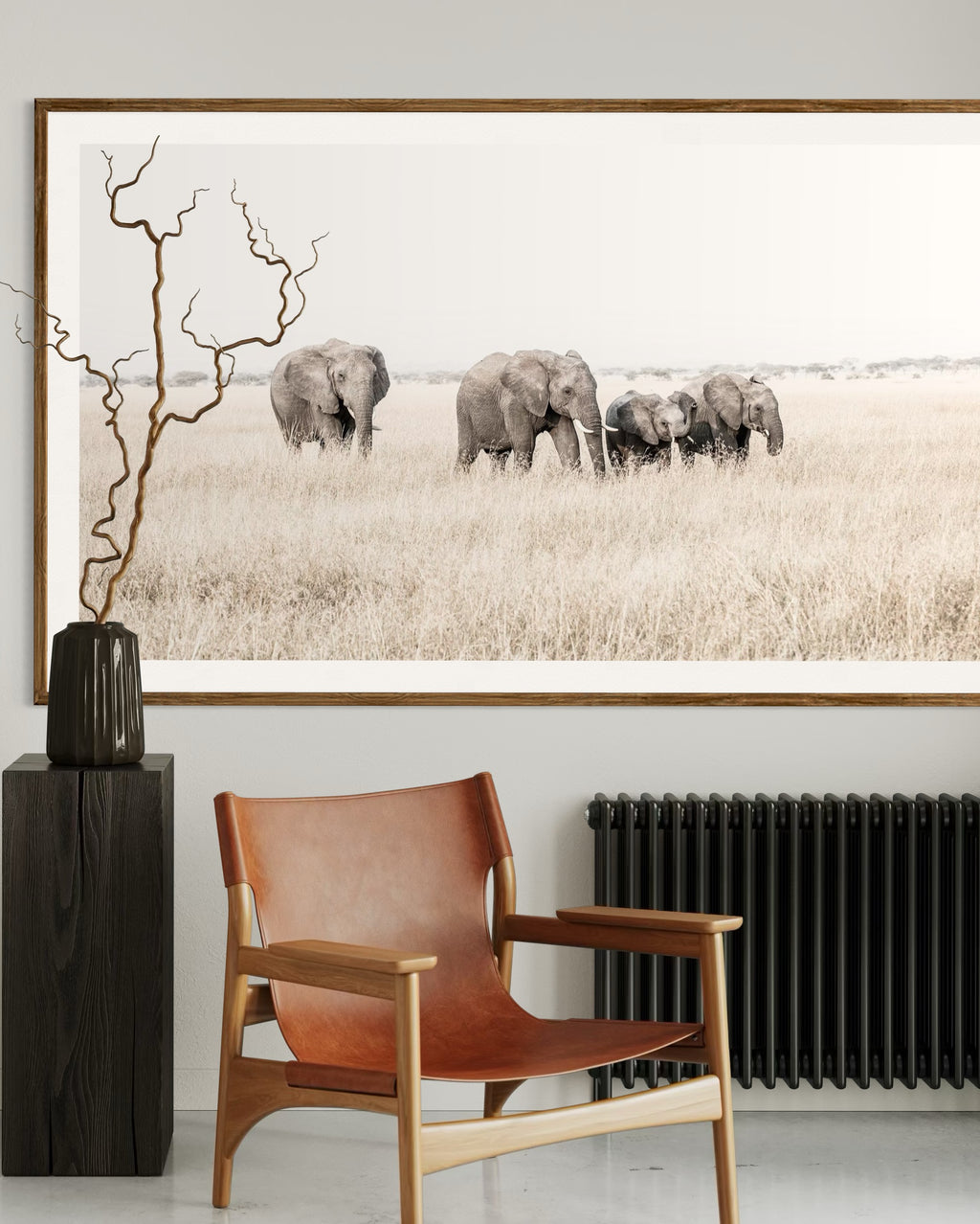 Modern interior featuring a framed artwork of a portrait of a family of elephants waling through grass by Francoise V Fine Art Gallery in Cape Town, South Africa