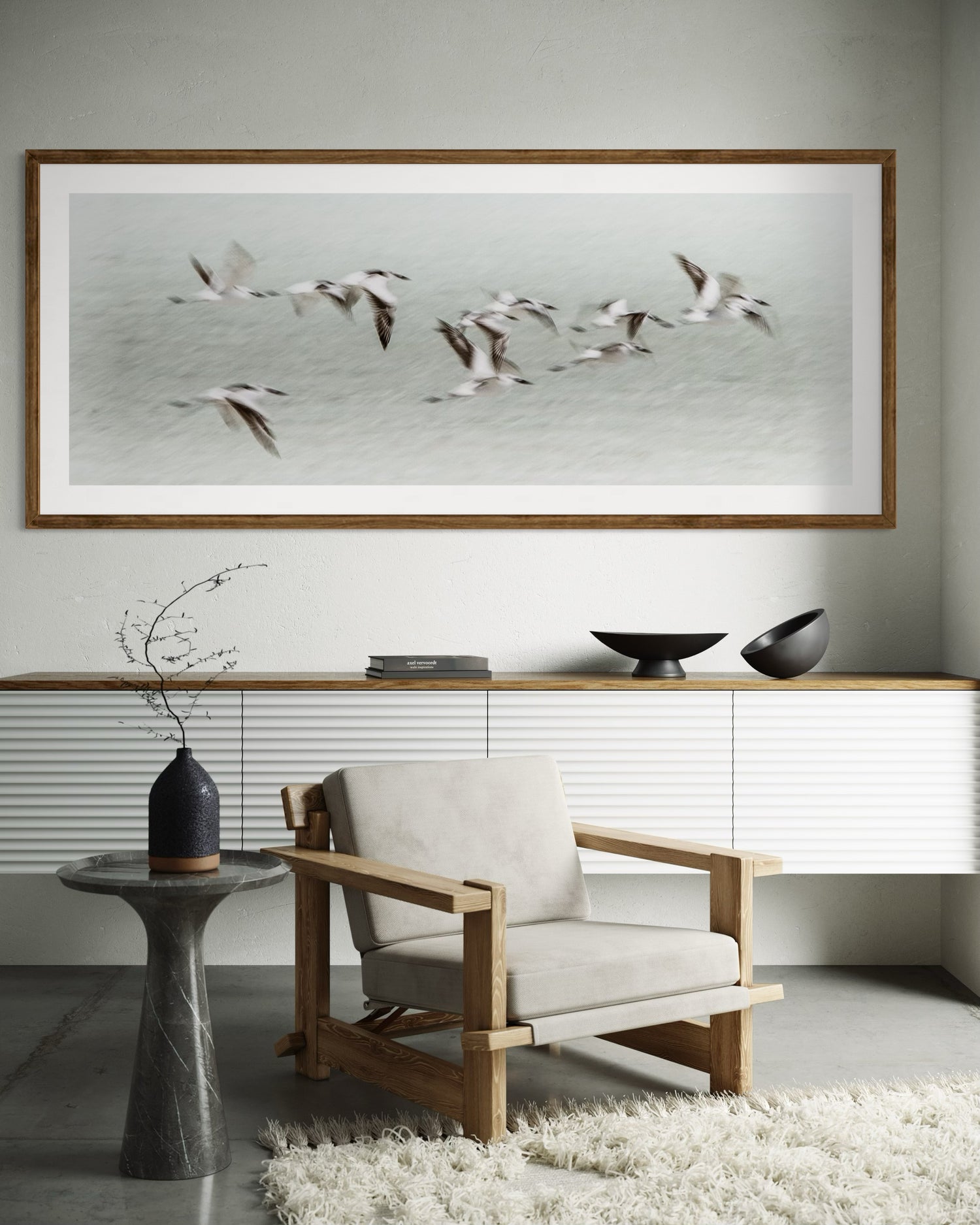Modern interior with a framed artwork of kenyan tern birds in flight and flying over the ocean.