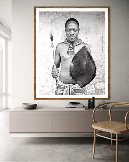Modern interior featuring a Black and white portrait of a man holding a shield and spear against a textured wall by Francoise V Fine Art Gallery in Cape Town, South Africa
