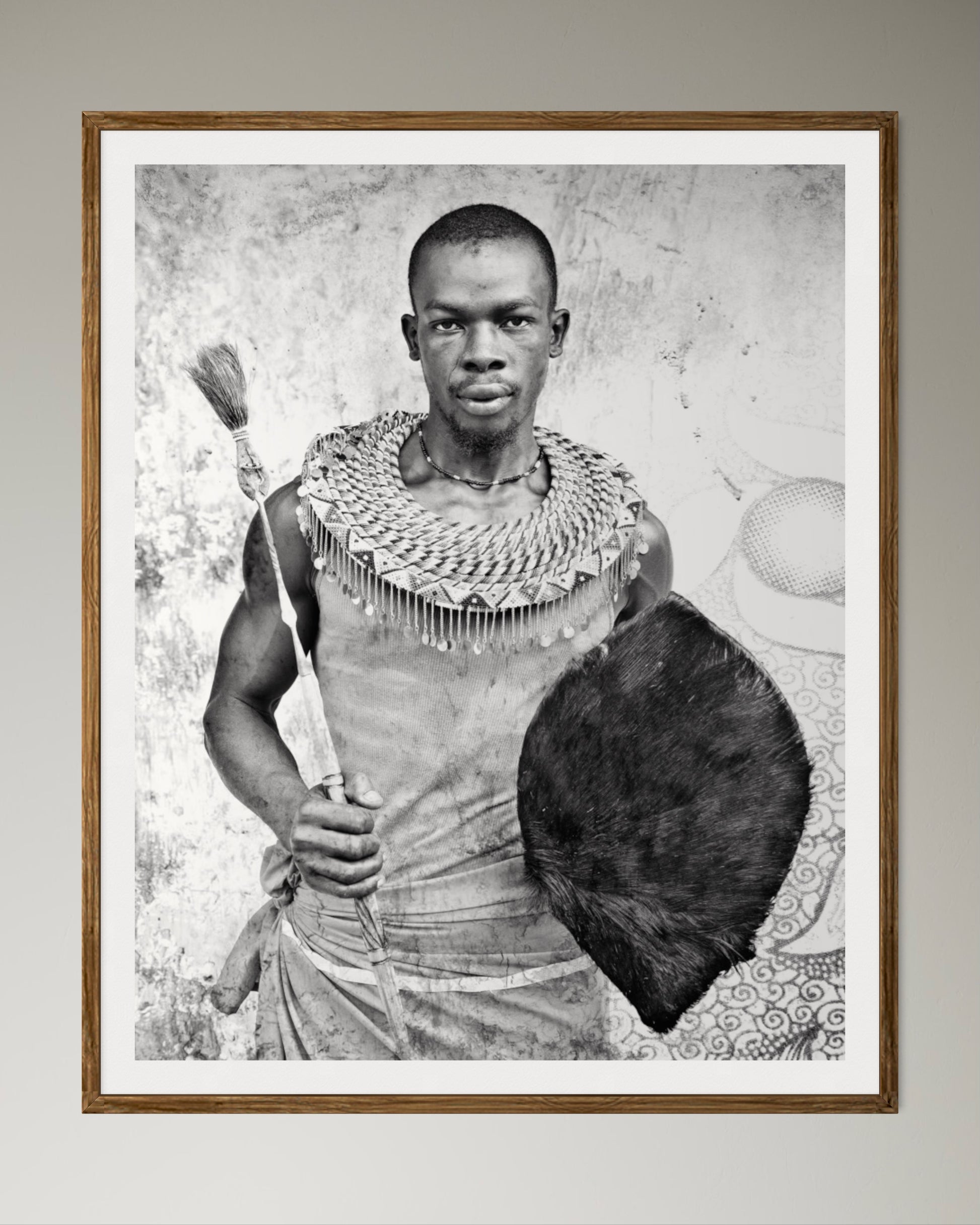 Natural Wood Kiaat framed Black and white portrait of a man holding a shield and spear against a textured wall by Francoise V Fine Art Gallery in Cape Town, South Africa